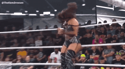 Woman Standing In Wrestling Ring Before Crowd GIF