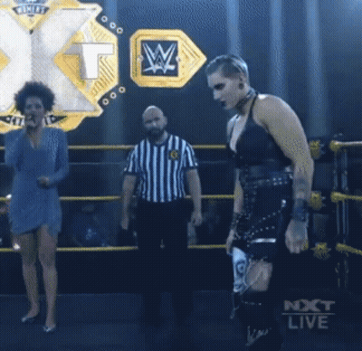 Woman Standing In Wrestling Ring Next To Referee And Next Live Sign GIF