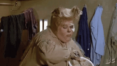 Woman Standing Near Clothes Rack GIF