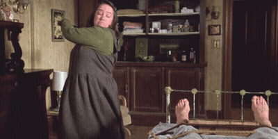 Woman Standing Next To Bed Holding Stick GIF