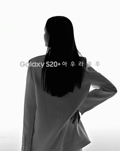 Woman Standing Next To Blue Phone With Korean Writing GIF