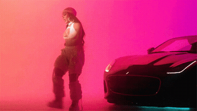 Woman Standing Next To Car Pink Background GIF