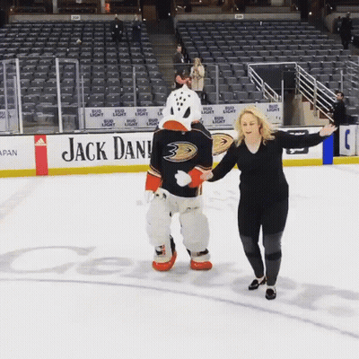 Woman Standing Next To Duck Mascot GIF