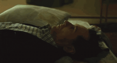 Woman Standing Next To Man Laying On Bed With True Logo GIF