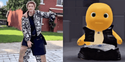 Woman Standing Next To Yellow Stuffed Animal With Black Vest GIF
