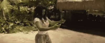 Woman Standing On Beach In Front Of Hut GIF
