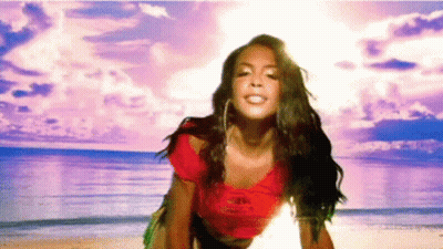 Woman Standing On Beach In Front Of Ocean GIF