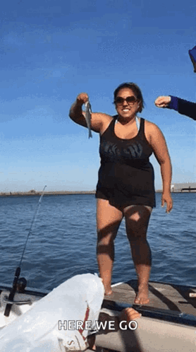 Woman Standing On Dock Holding Fish GIF