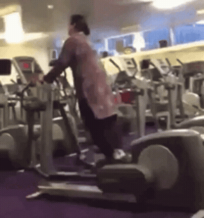 Woman Standing On Elliptical Machine GIF