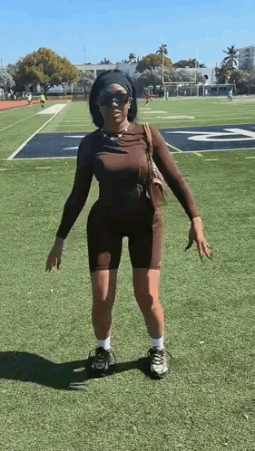 Woman Standing On Football Field GIF