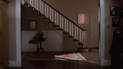 Woman Standing On One Leg In Front Of Staircase GIF