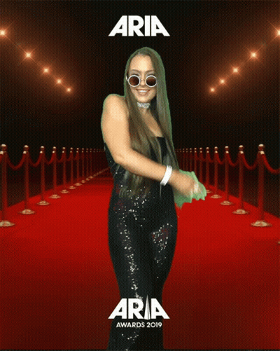 Woman Standing On Red Carpet At Aria Awards GIF