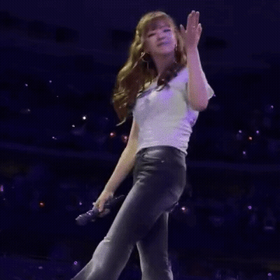 Woman Standing On Stage In Front Of Crowd GIF
