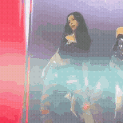 Woman Standing On Stage In Front Of Red Light GIF