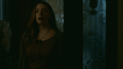 Woman Standing With Eyes Closed In Dark Room GIF