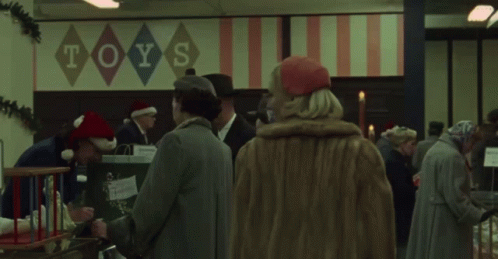 Woman Stands In Front Of Toys Sign GIF
