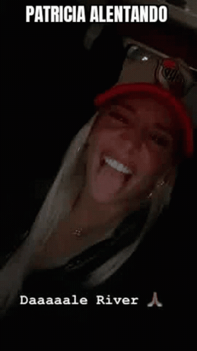 Woman Sticking Tongue Out In Red Hat GIF