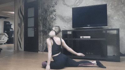 Woman Stretching In Front Of TV GIF