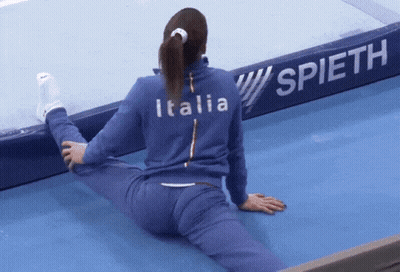 Woman Stretching Legs In Front Of Spieth Sign GIF