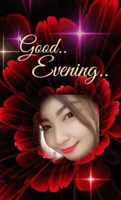 Woman Surrounded By Red Flowers Saying Good Evening GIF