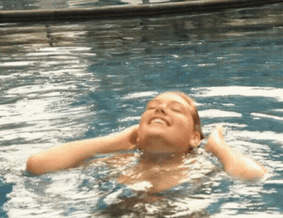 Woman Swimming In Pool Eyes Closed Smiling GIF