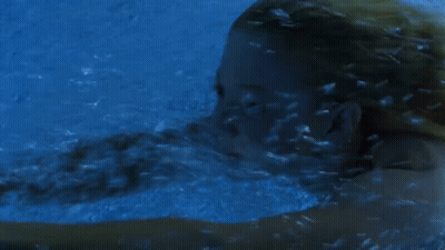 Woman Swimming Underwater In Blue Pool GIF