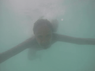 Woman Swimming Underwater Smiling GIF