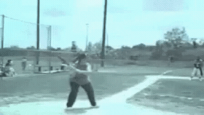 Woman Swinging Bat At Baseball On Field GIF