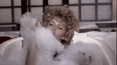 Woman Taking Bath In Soap Bubbles GIF