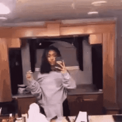 Woman Taking Mirror Selfie In Kitchen GIF