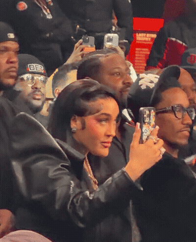 Woman Taking Picture Of Man In DST Hat GIF