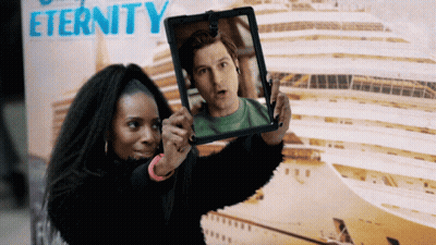 Woman Taking Picture Of Man In Front Of Eternity Sign GIF