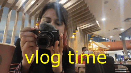 Woman Taking Picture With Sony Camera In Restaurant GIF