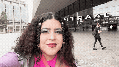 Woman Taking Selfie In Front Of Intraal Building GIF