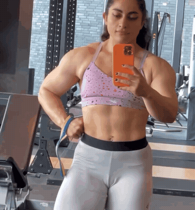 Woman Taking Selfie In Gym With Orange Phone GIF