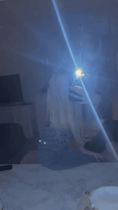Woman Taking Selfie In Mirror With Blue Light GIF