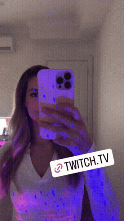 Woman Taking Selfie In Mirror With Glow In The Dark Paint GIF