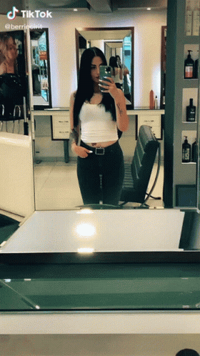 Woman Taking Selfie In Mirror With TikTok GIF
