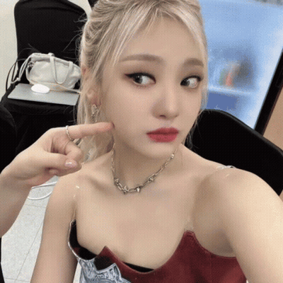 Woman Taking Selfie With Finger On Chin GIF