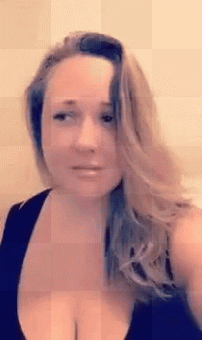Woman Taking Selfie With Visible Breasts In Black Tank Top GIF