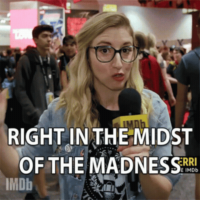 Woman Talking Into Microphone Right In The Midst Of Madness GIF