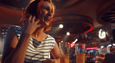 Woman Talking On Cell Phone At Bar GIF