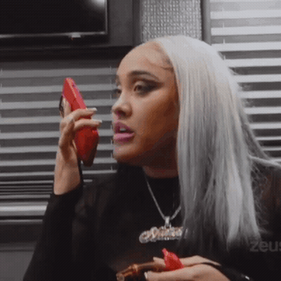 Woman Talking On Cell Phone Holding Cigar GIF