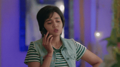 Woman Talking On Cell Phone In Striped Shirt And Denim Vest GIF