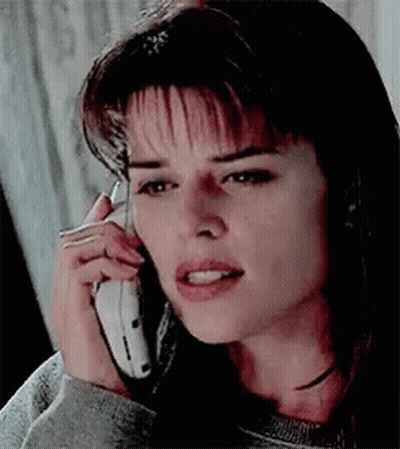 Woman Talking On Cell Phone Making Funny Face GIF