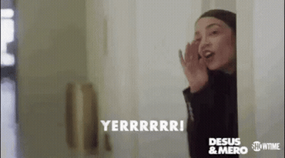Woman Talking On Cell Phone Peeking Out Door GIF