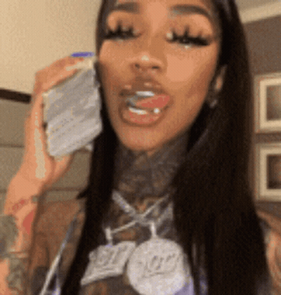 Woman Talking On Cell Phone With Necklace GIF