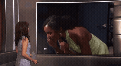 Woman Talking On Old Fashioned Telephone In Mirror GIF