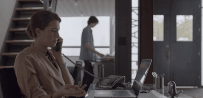 Woman Talking On Phone At Desk GIF