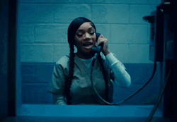 Woman Talking On Phone In Prison GIF